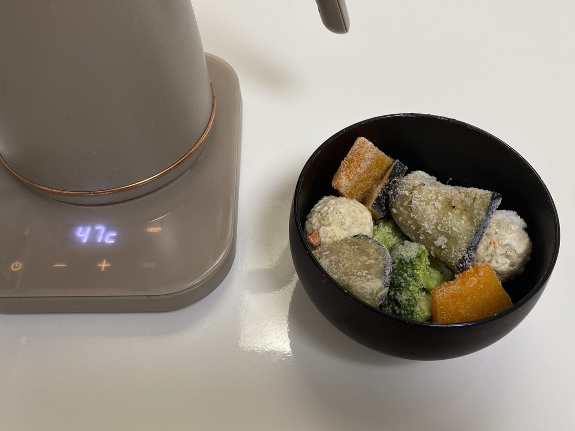 お椀に入った味噌汁の具材と電気ケトルの画像